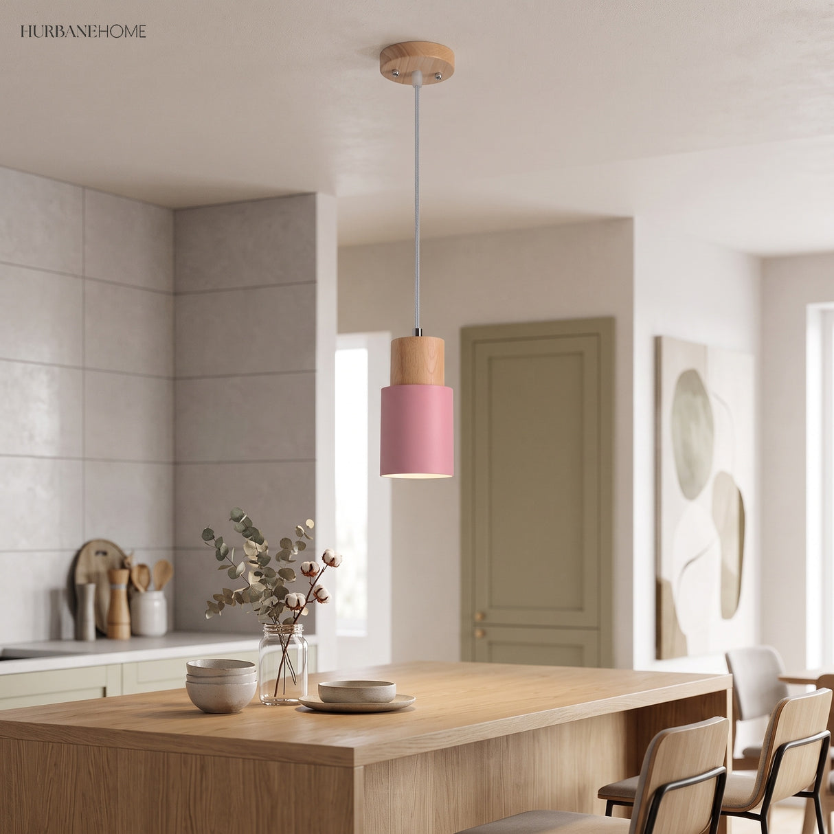 Pink cylinder pendant with a wood top above a kitchen island