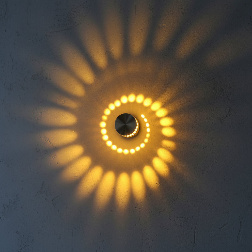 Close view of a yellow spiral pattern thrown across a wall
