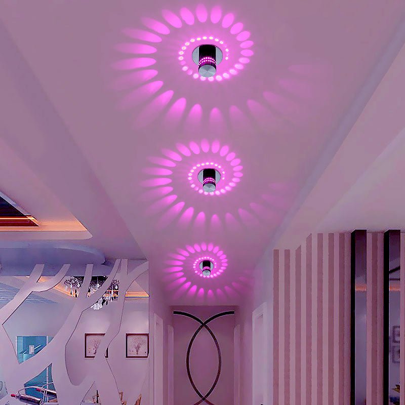 Spiral lights casting pink patterns on a ceiling in a pink room