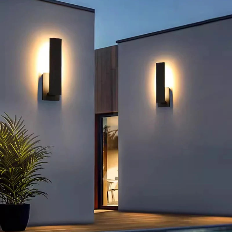 LED wall sconce illuminating exterior wall at night