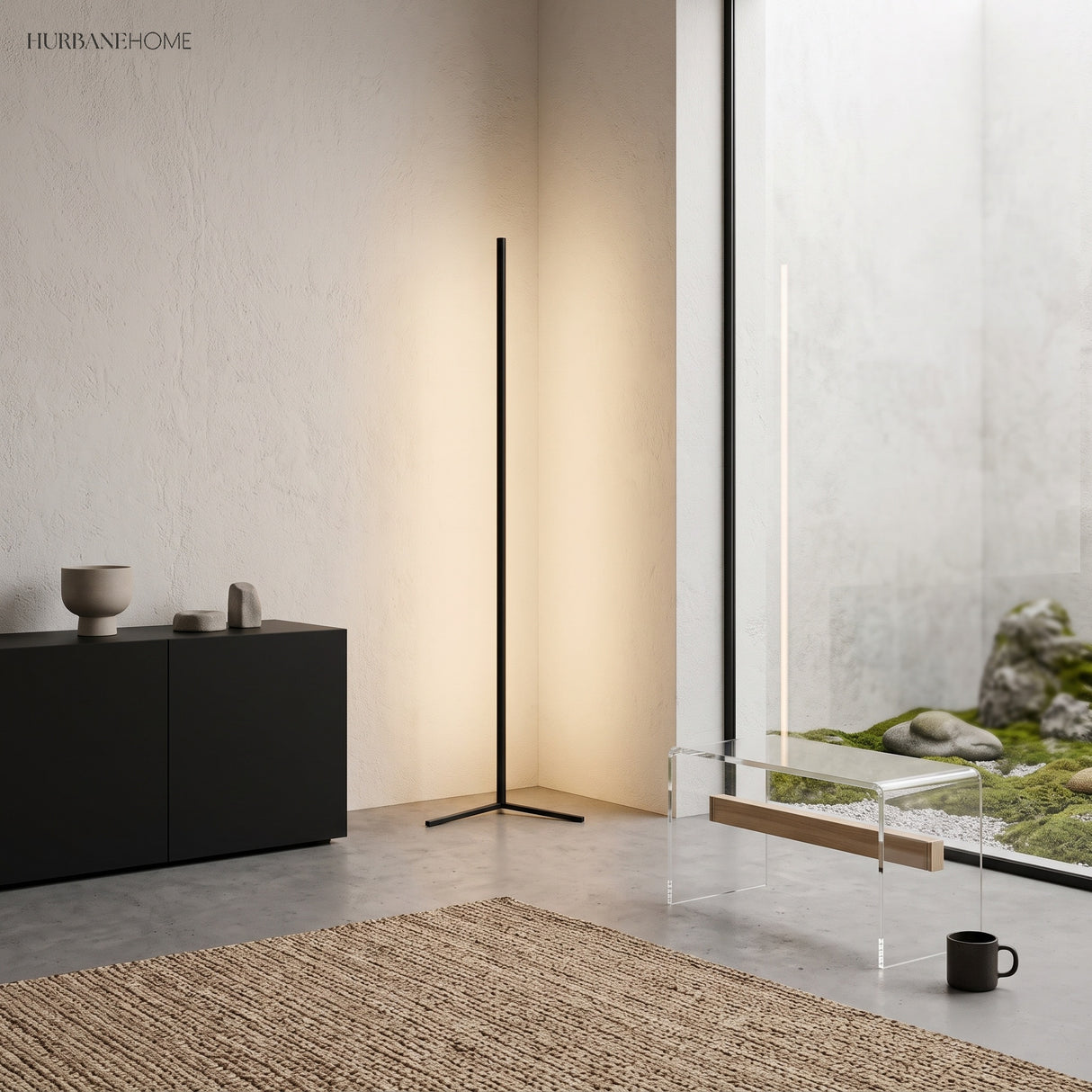 Black corner floor lamp beside a low sideboard and jute rug in a bright living room