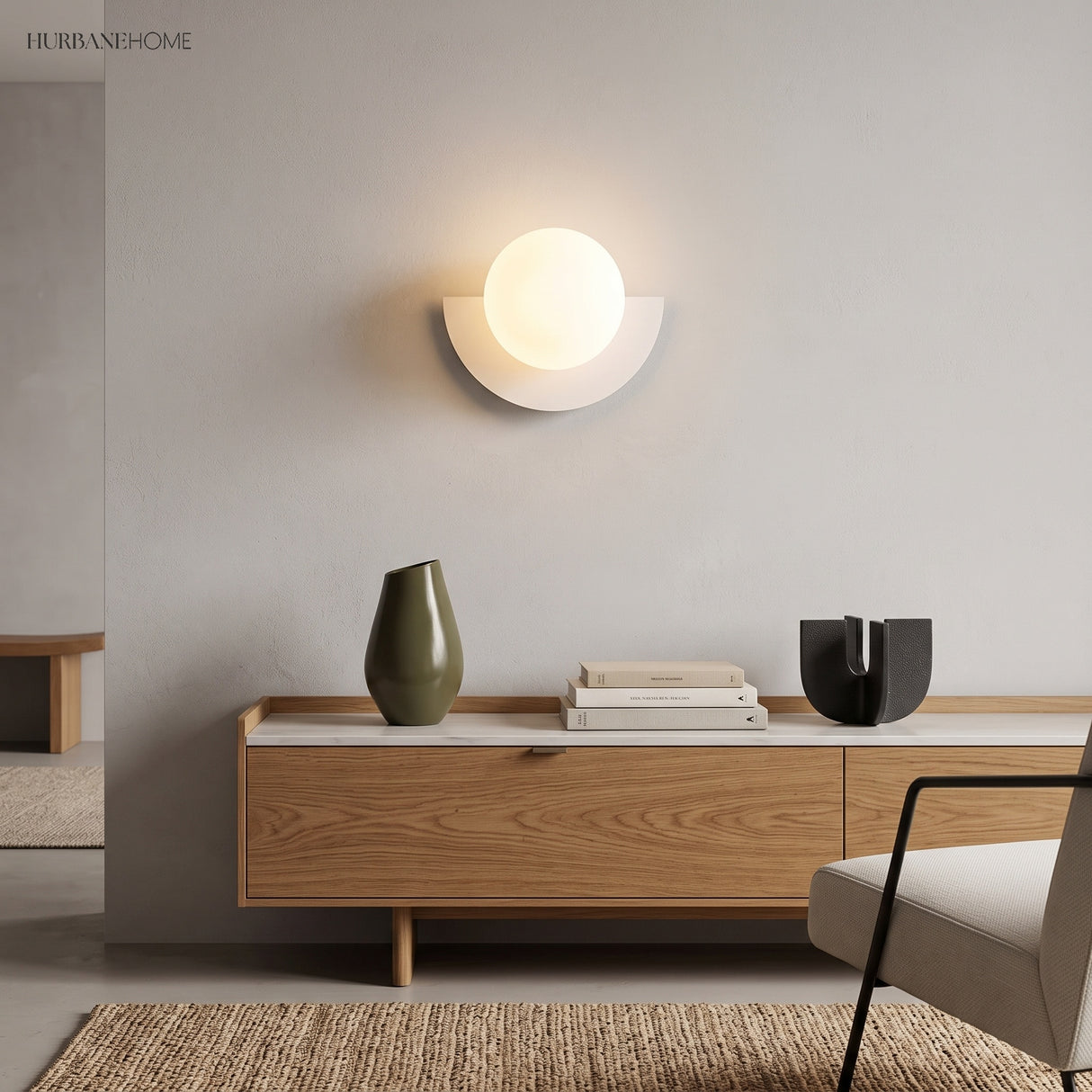 White glass globe wall sconce above a wood sideboard in a living room