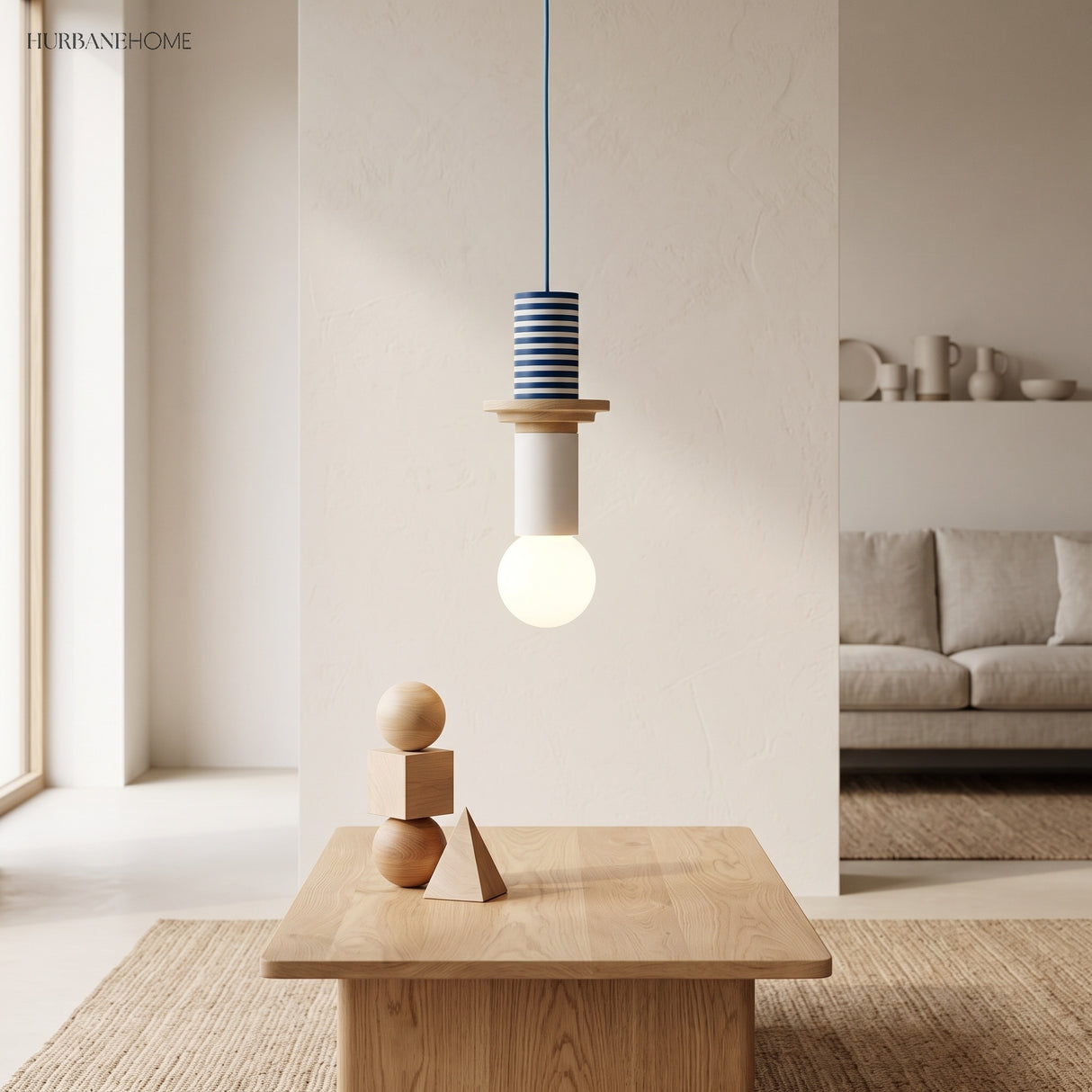 Blue striped geometric wood pendant light above a table with stacked wooden blocks