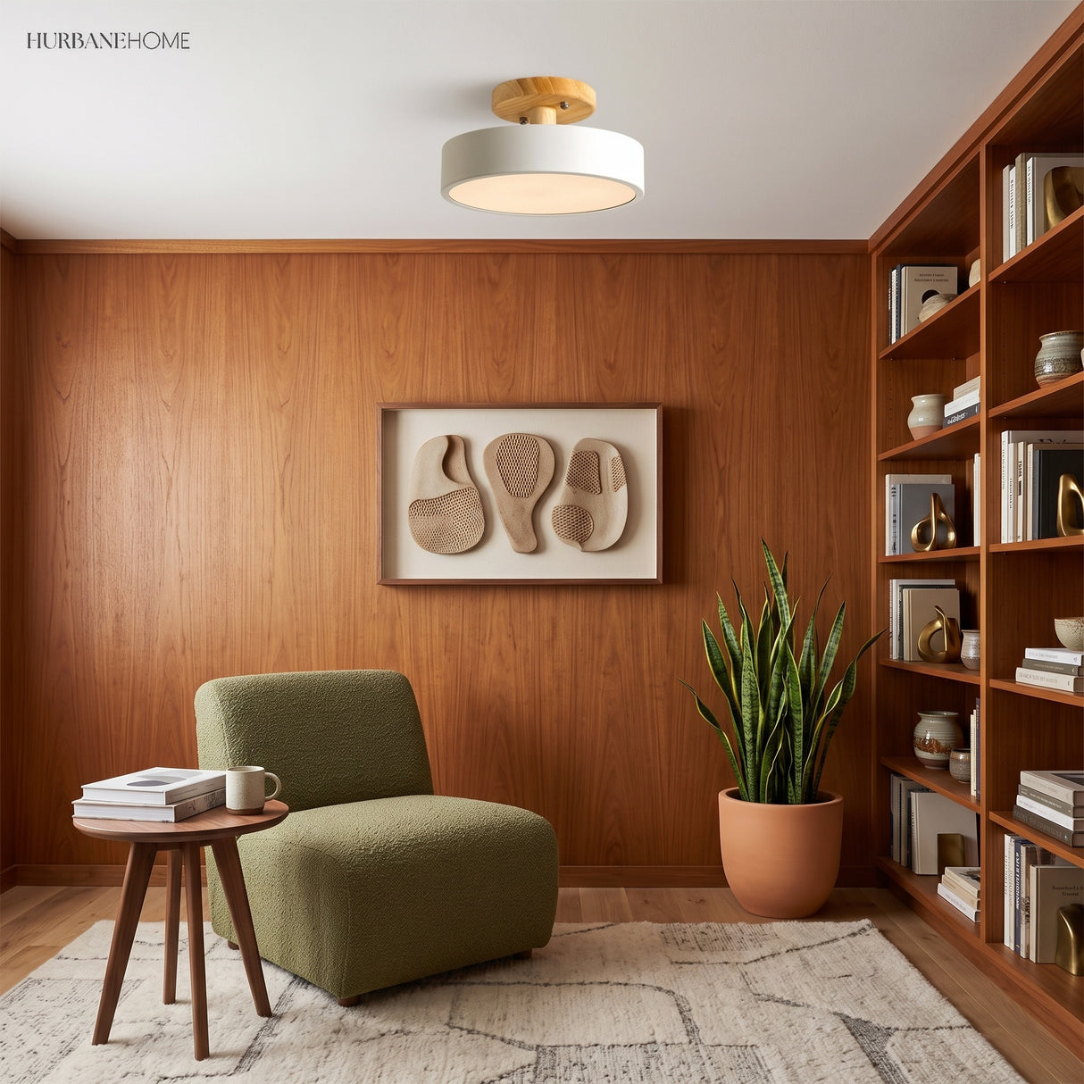 White wood ceiling light in a wood-panelled reading nook with a green chair
