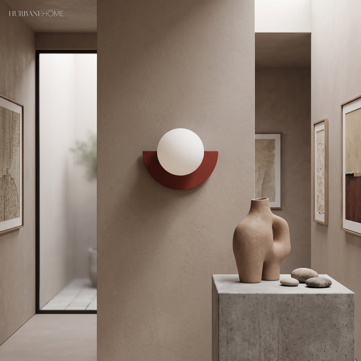 Deep red glass globe wall light on a warm plaster hallway wall