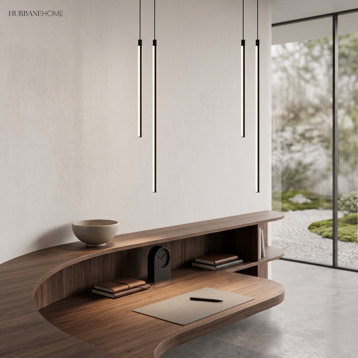 Four slim black tube pendants glowing warm white above a walnut desk