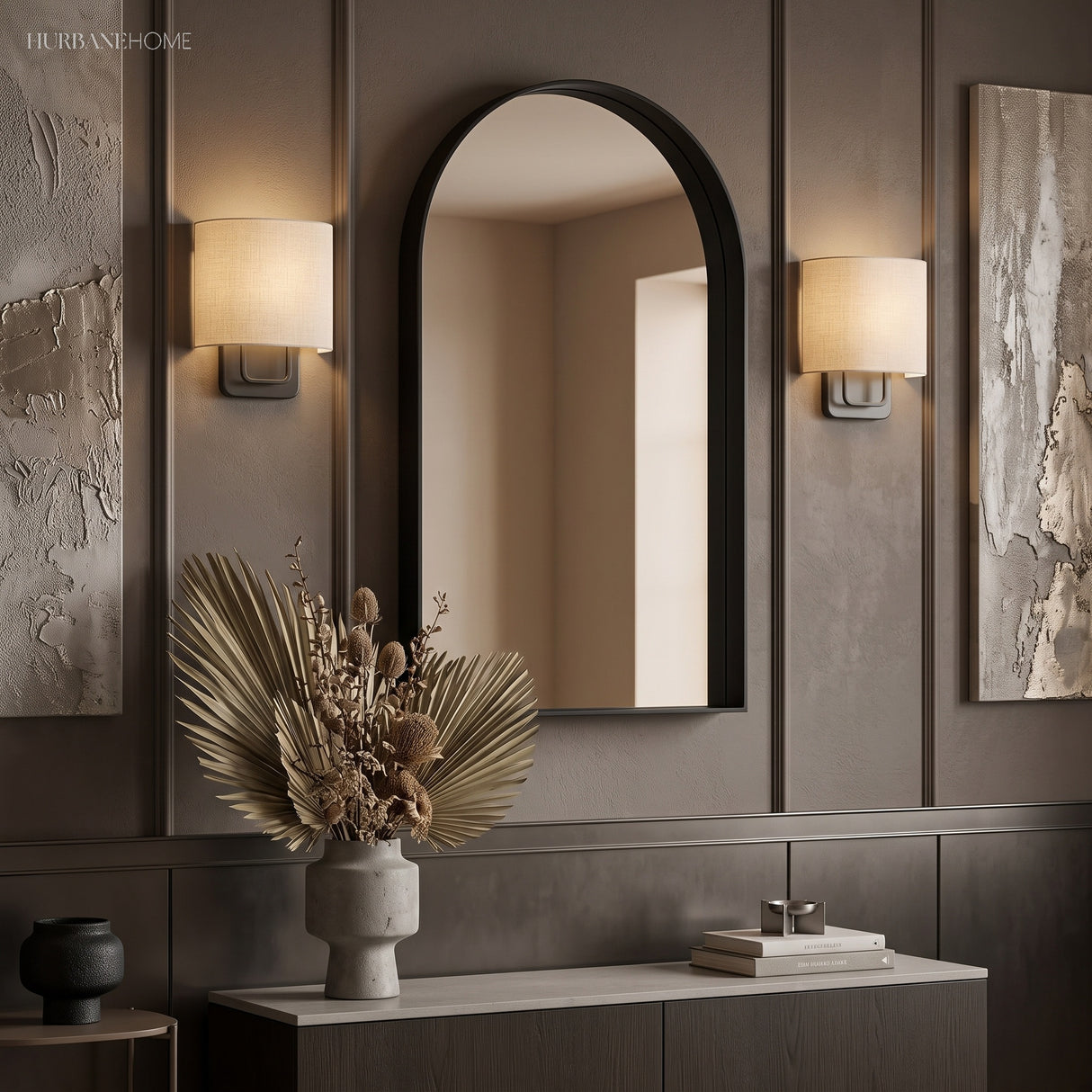 Two linen shade sconces flanking an arched mirror above a sideboard
