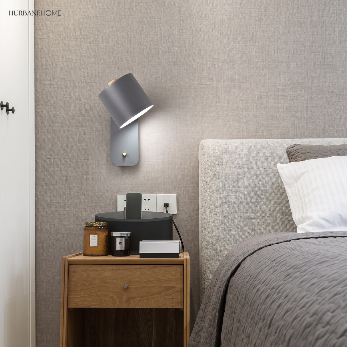 Rotatable cylinder wall sconce in a styled bedroom