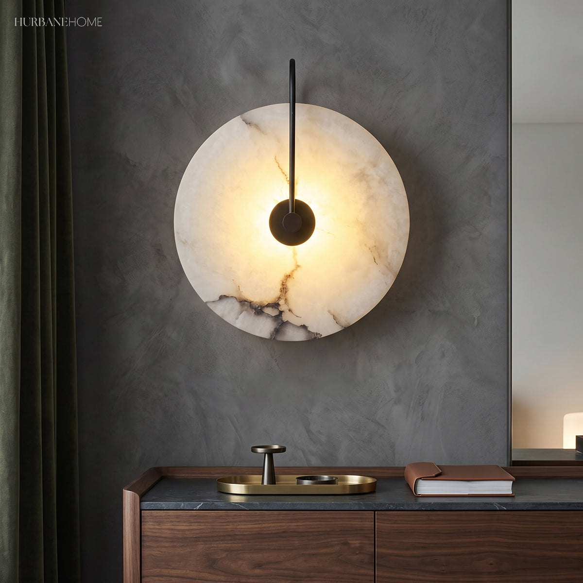 Backlit marble sconce on a grey wall above a brass basin