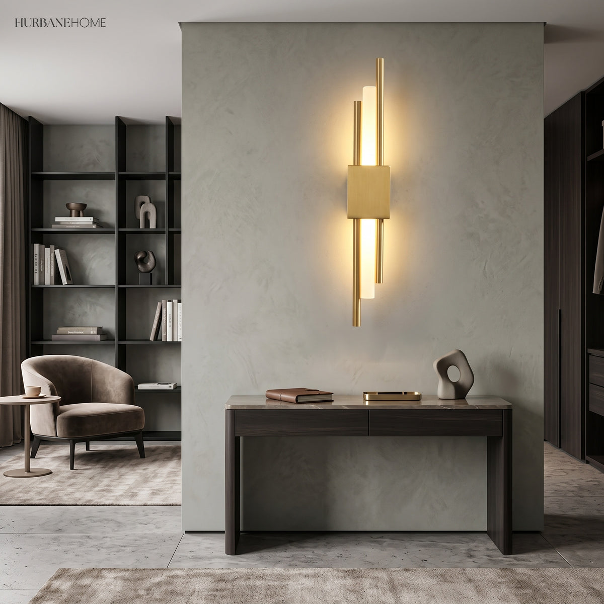 Gold linear sconce lit on a pale wall above a console table