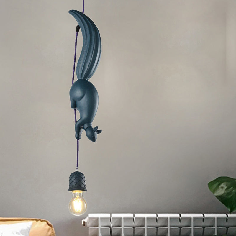 Two white squirrel pendants hung at different heights on grey