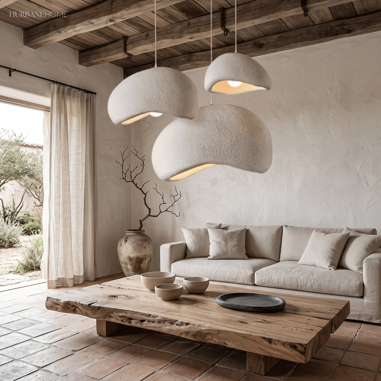 Grey minimalist pendant light cluster over a neutral living room sofa