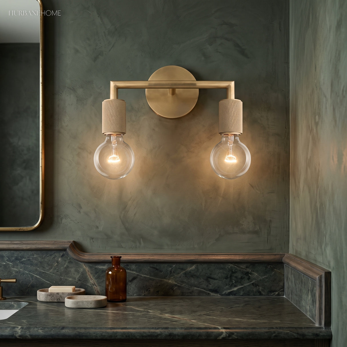 Two light brass sconce above a marble console and a wall mirror