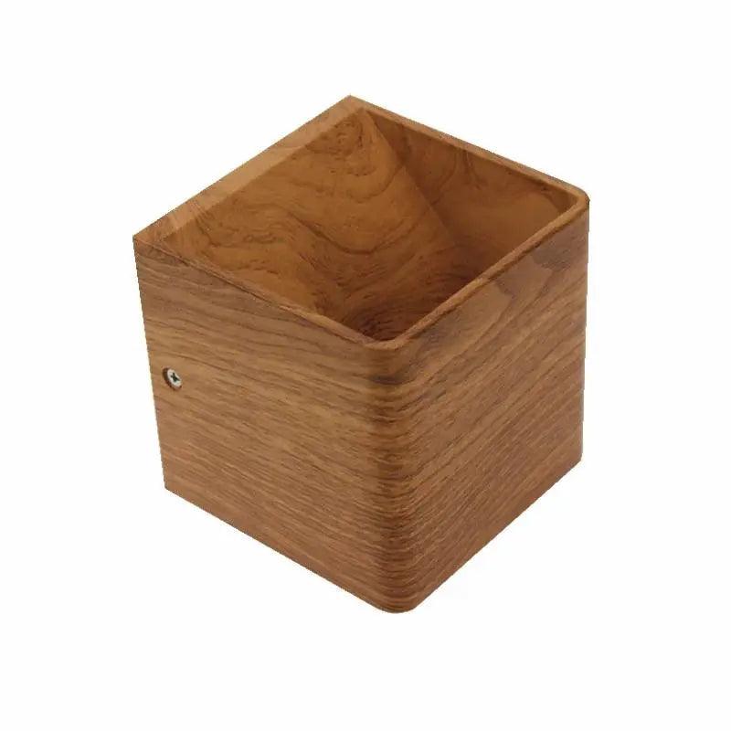 Wood cube wall sconce photographed alone from above on white