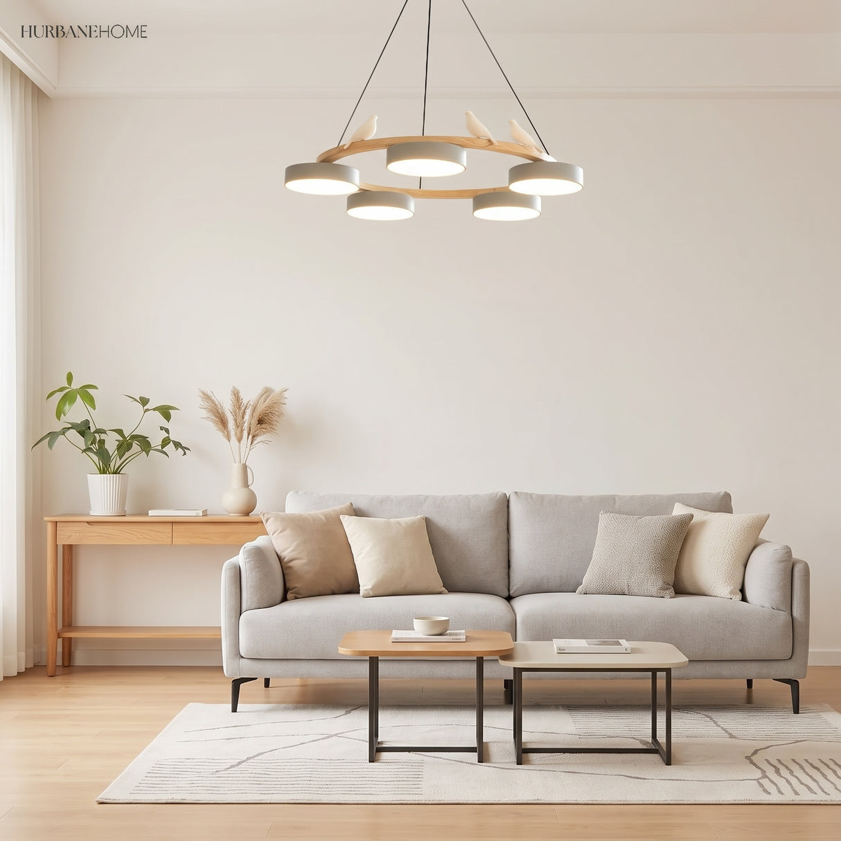 Wood ring chandelier with white shades over a grey sofa in a bright living room