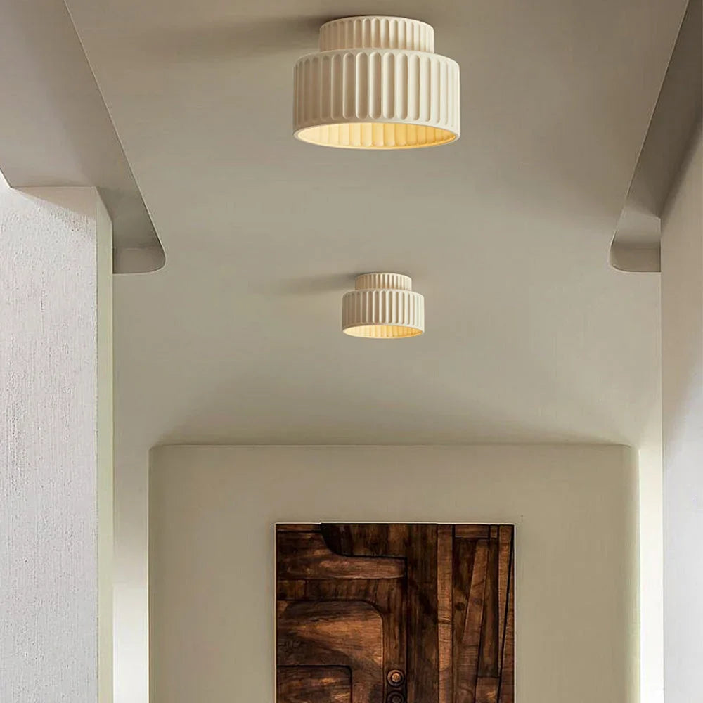 Modern flush mount ceiling light shown in profile to display its two stacked tiers