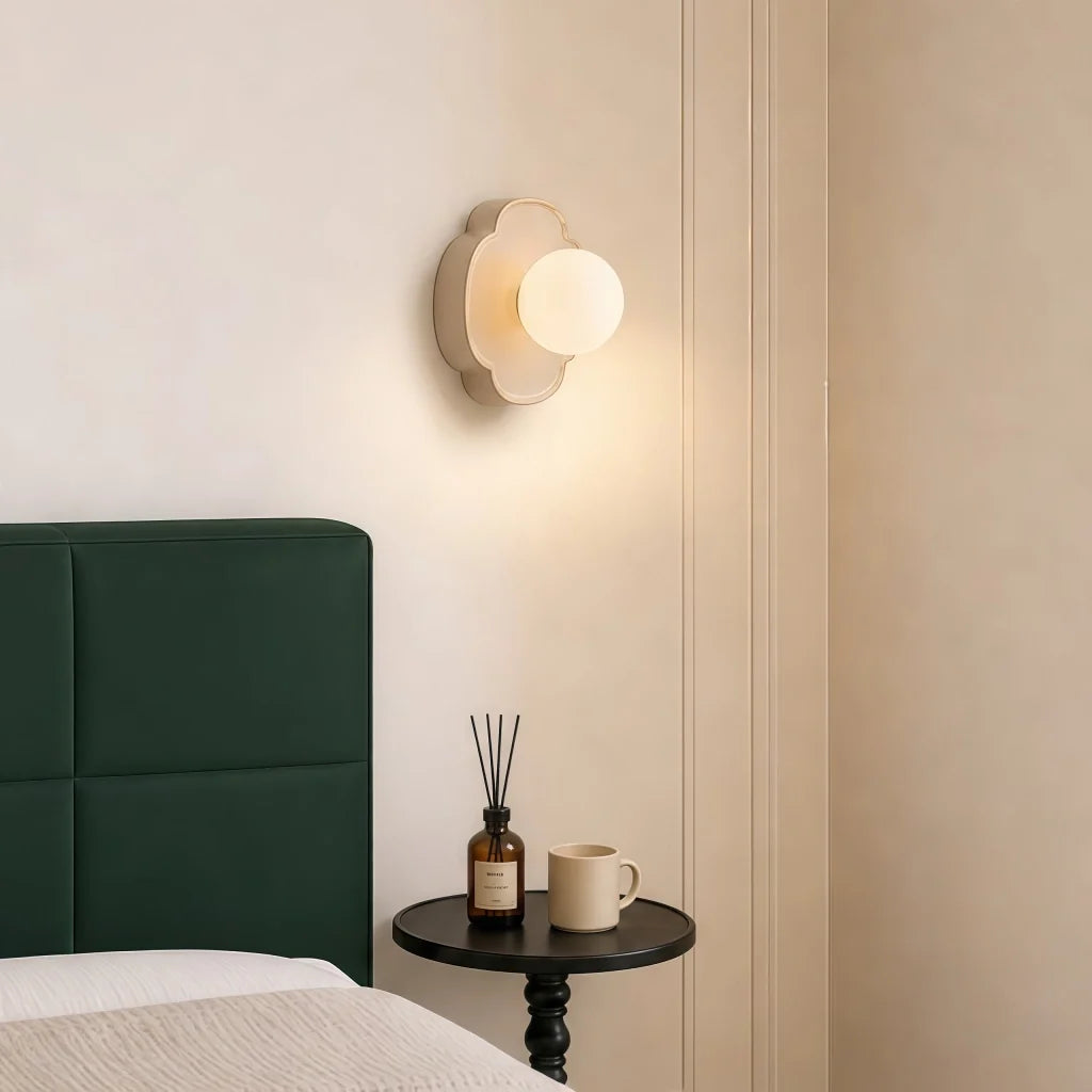 Mocha brown orb wall sconce with glowing white glass globe shade
