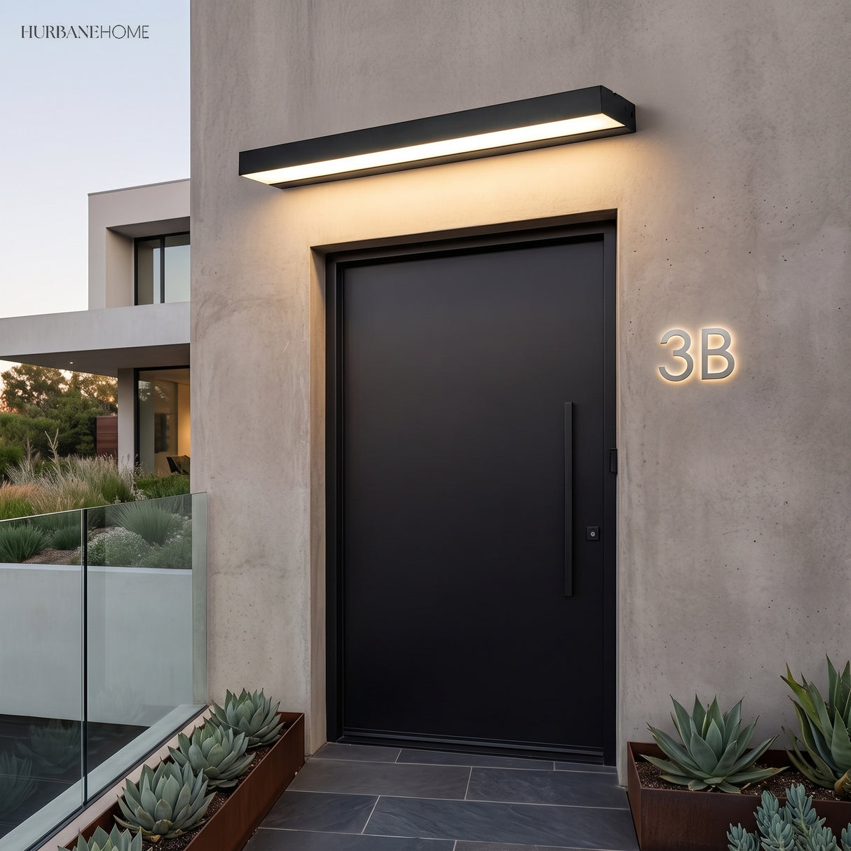 Linear outdoor light above a dark entry door on a rendered wall