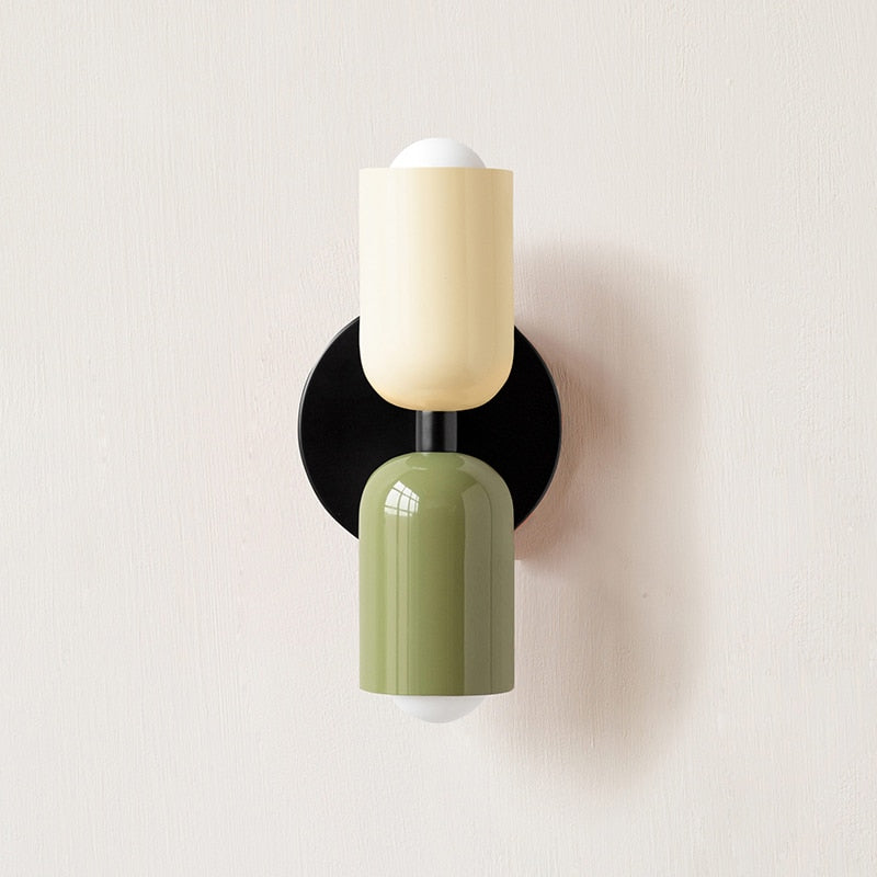 Cream and olive cylinders on a black round backplate