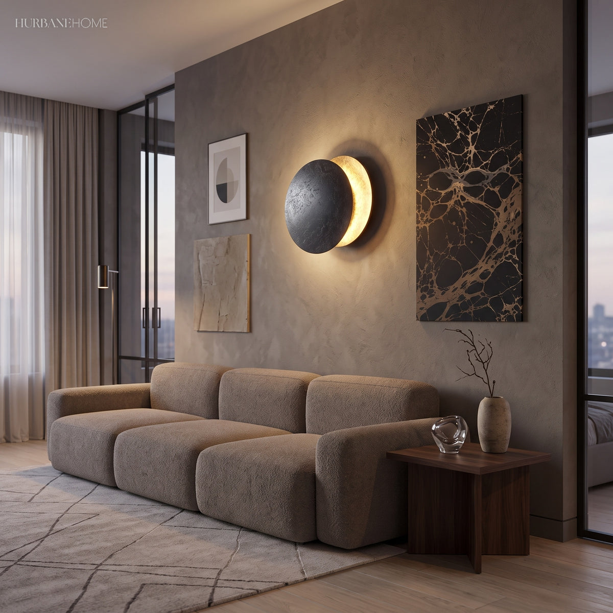 Moon eclipse sconce glowing against a deep blue textured wall