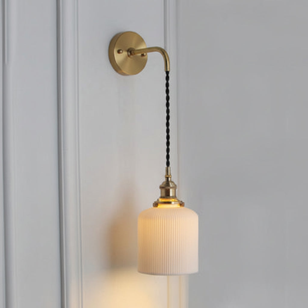 Slim capsule shade glowing dimly on a cord in a panelled hall