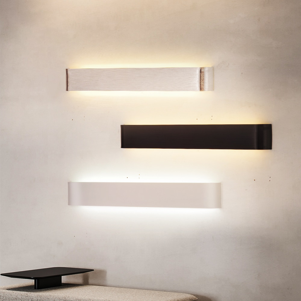Three linear wall sconces stacked on a wall beside a dining table