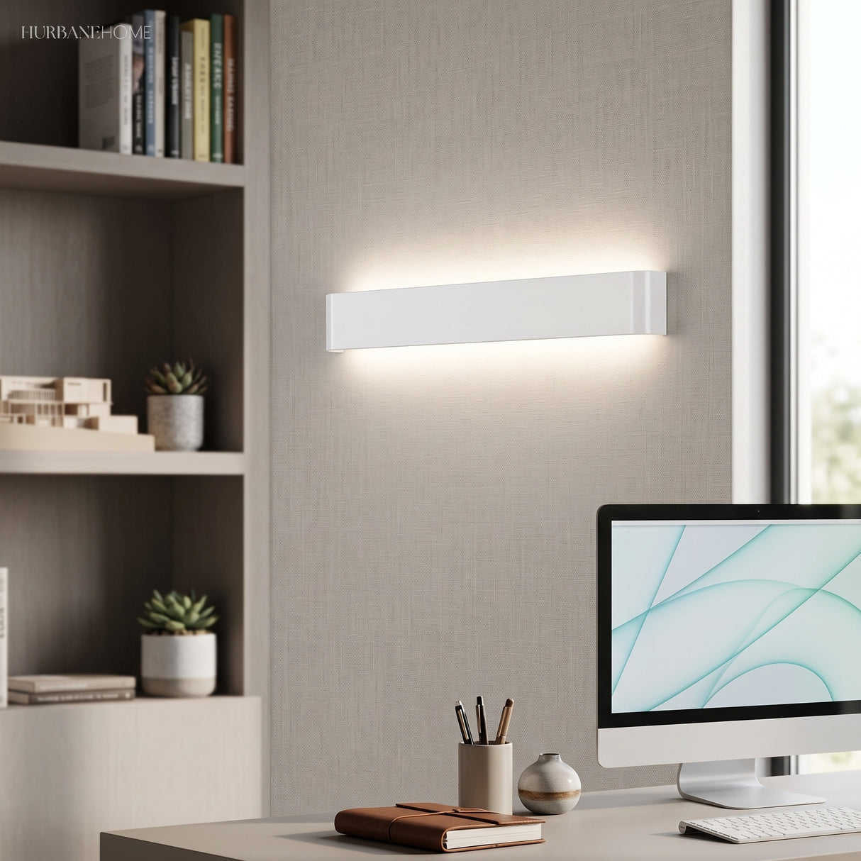 White linear wall sconce lit above a desk and shelving