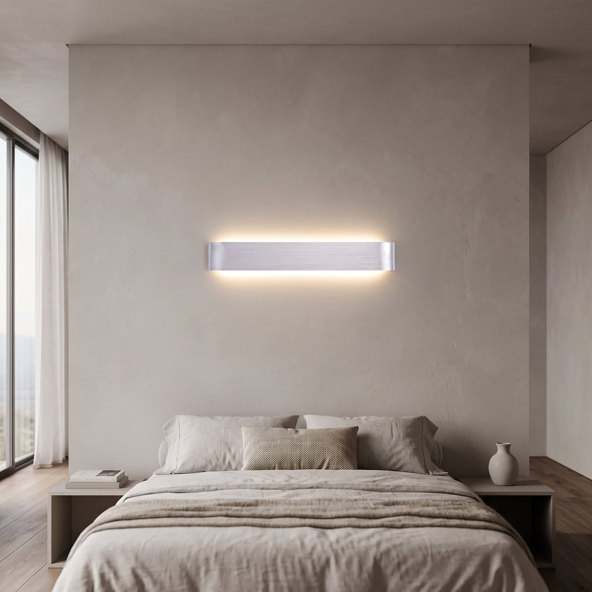Silver linear LED wall sconce lit above a bed with pale bedding
