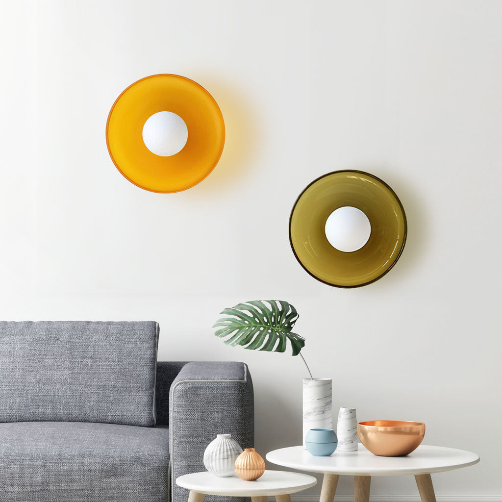 Orange and brown glass disc light on a ceiling
