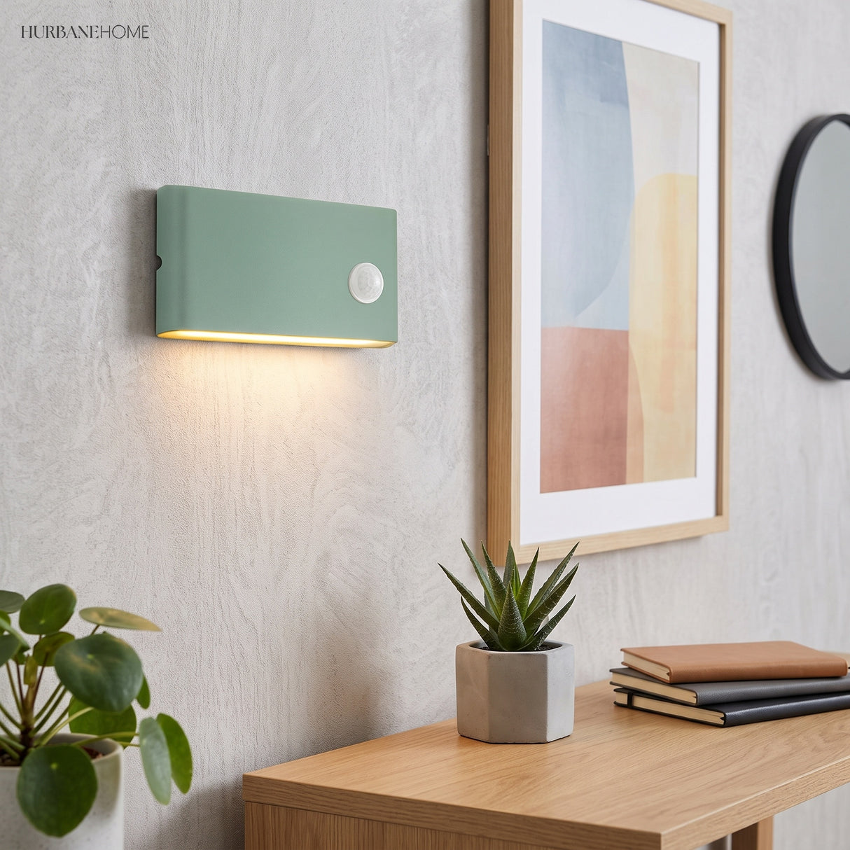 Green motion sensor wall light beside framed art on a light wall