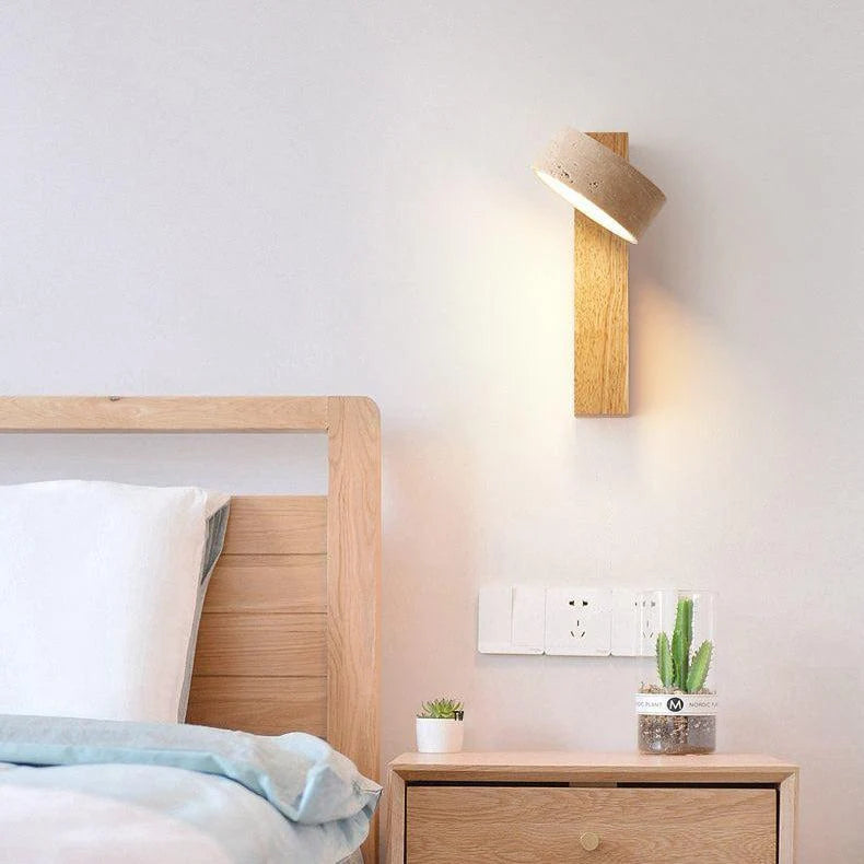 Natural wood travertine wall sconce lighting a calm bedroom in warm tones