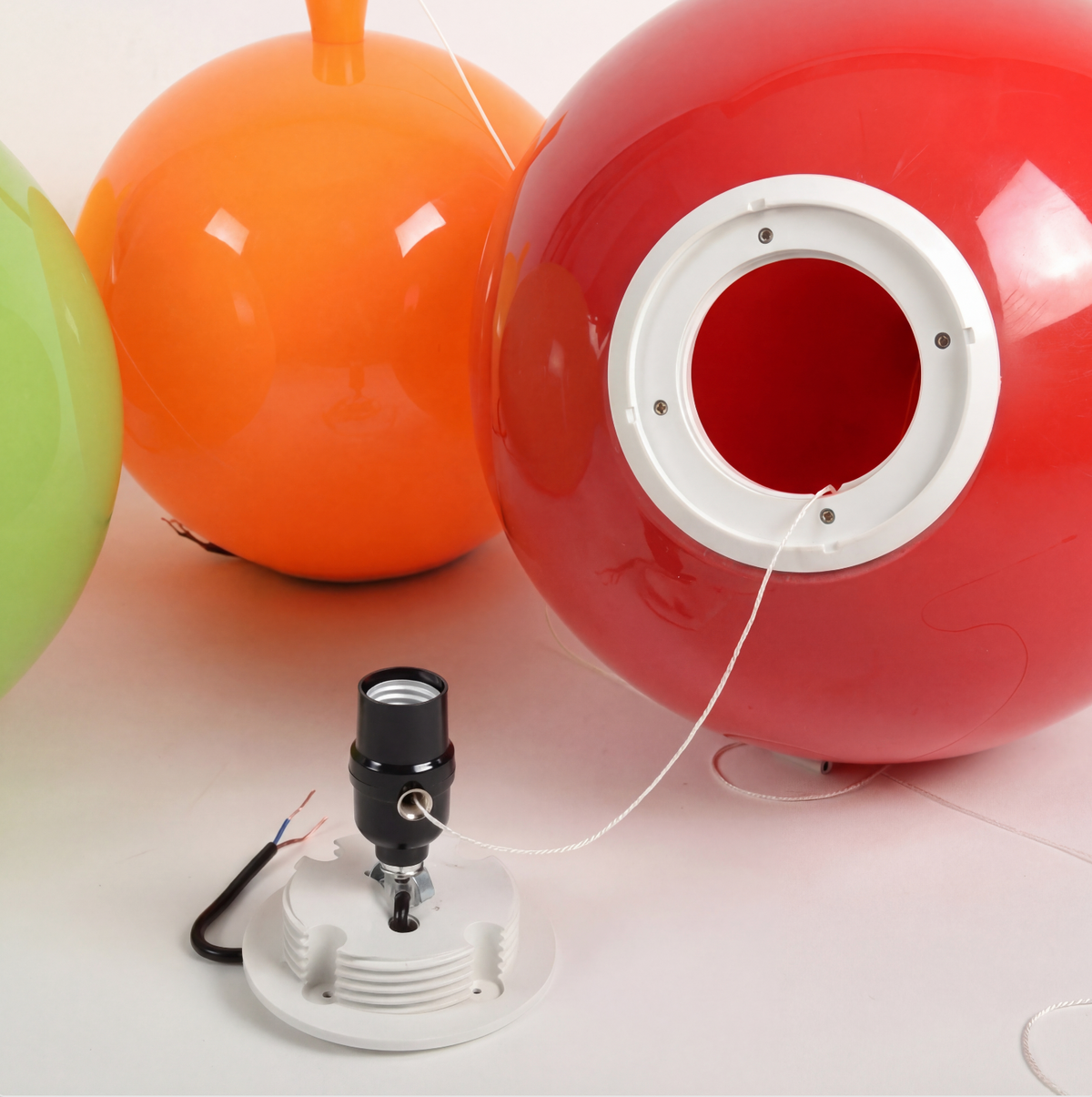 Two balloon shades showing the open back and lamp holder