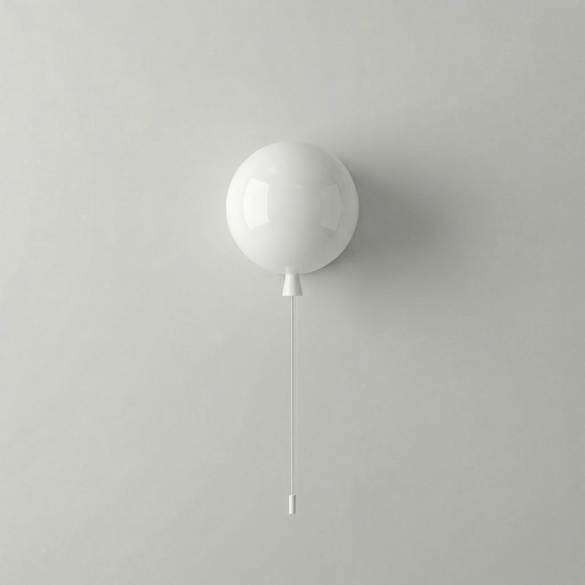 White balloon light mounted on a pale grey wall with a pull cord
