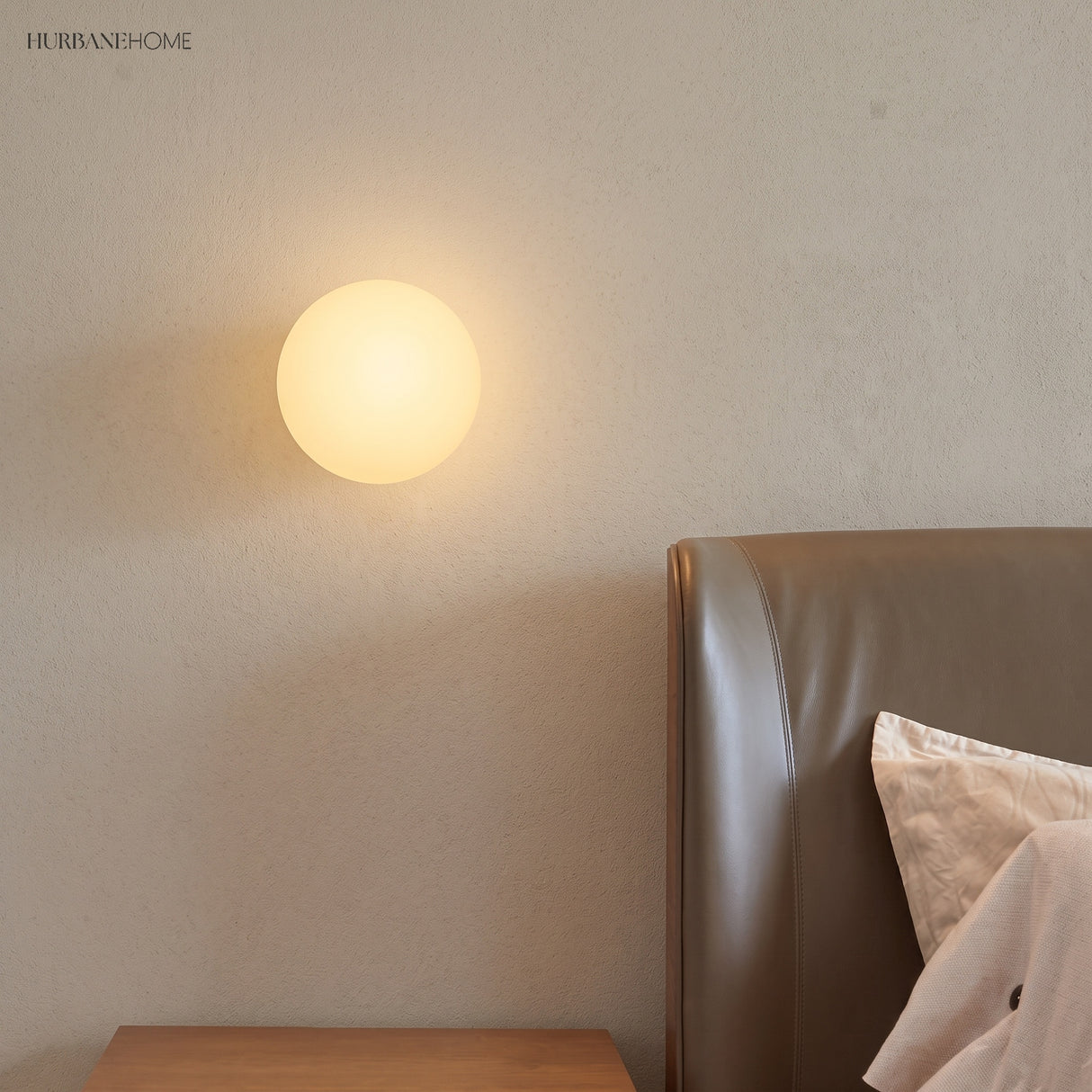 Frosted glass orb wall sconce in a styled interior