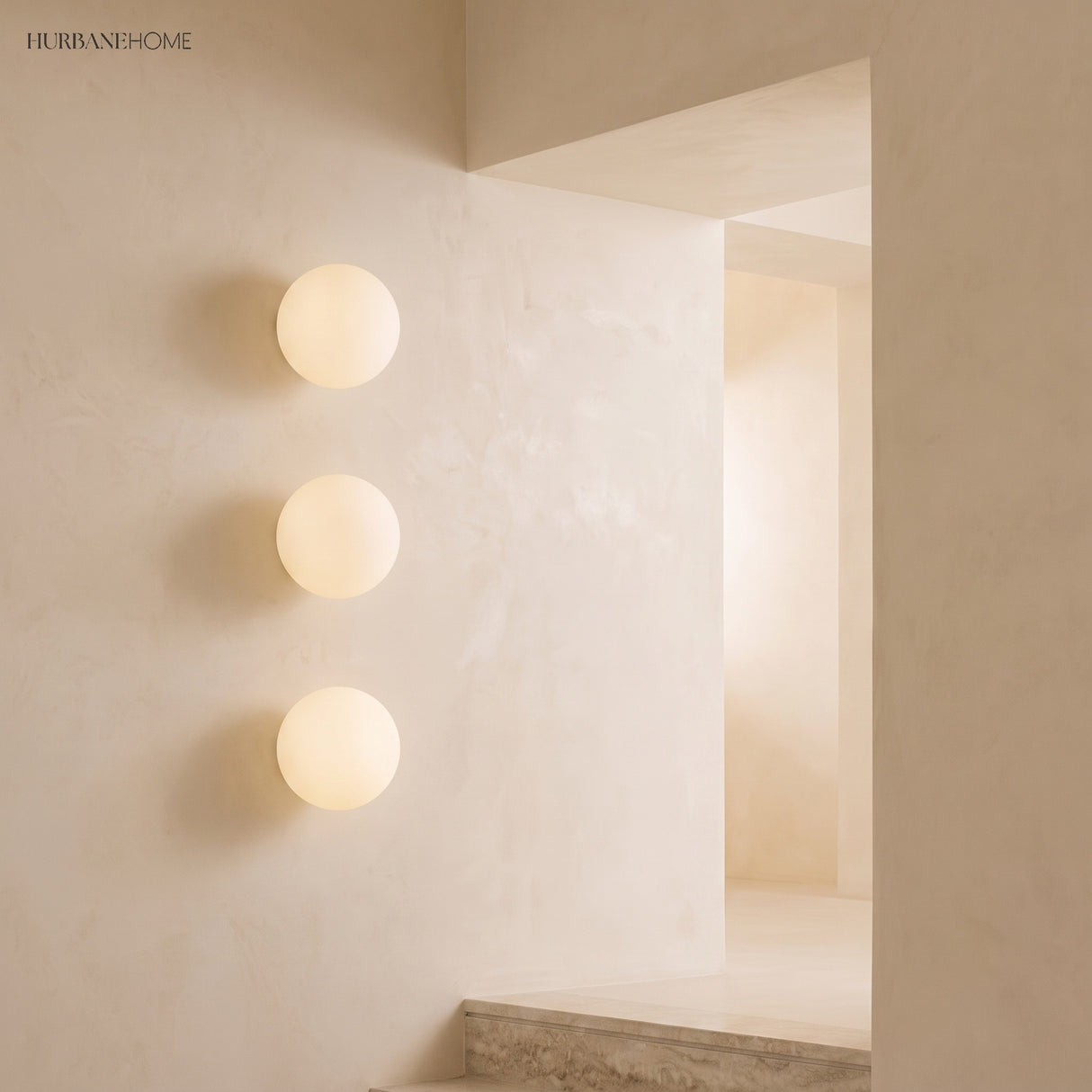 Frosted glass orb wall sconces in a styled interior