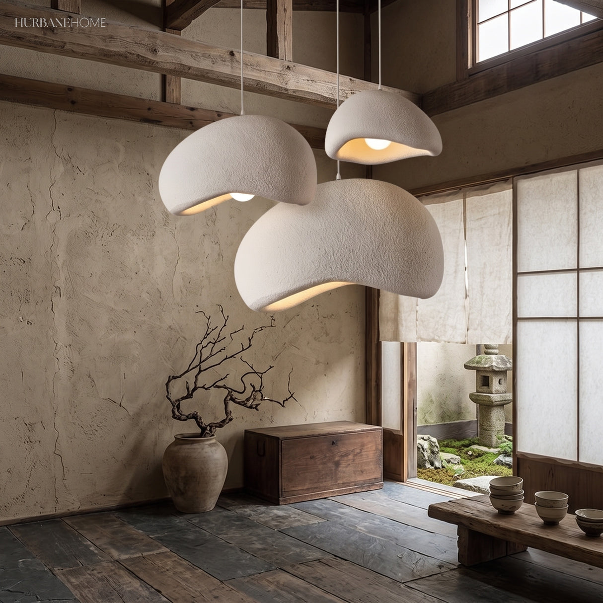 Three white organic dome pendant lights in a calm Japandi interior