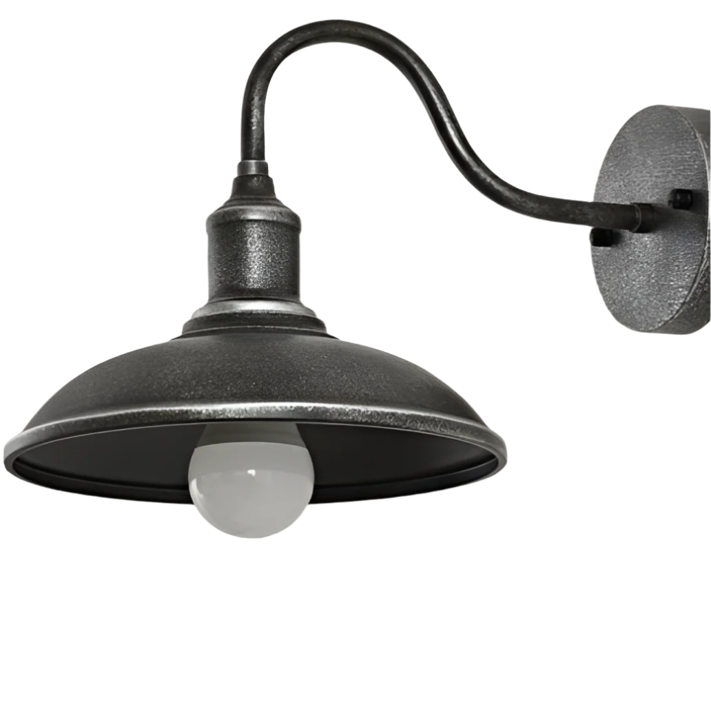 Antique silver barn light seen from the side on a white ground