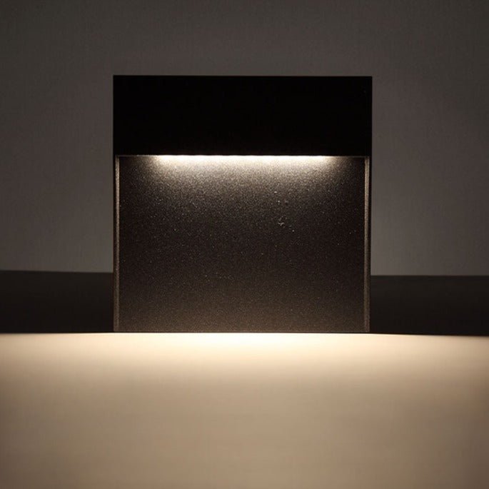 Close view of warm light spilling from the step light onto a wall