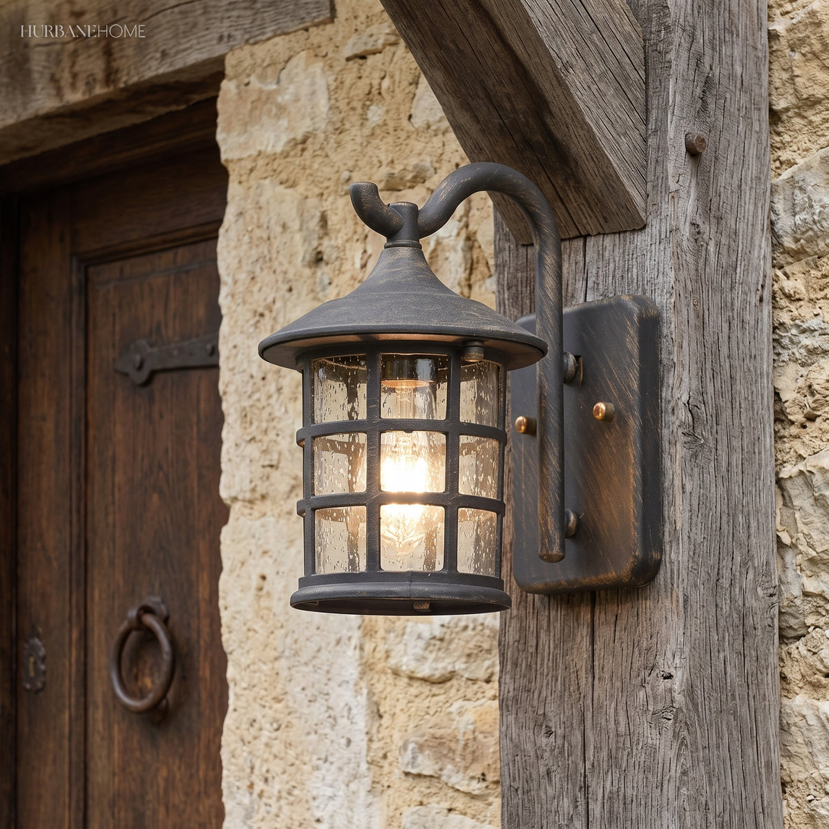 Lantern wall light on a sandstone wall beside a studded door