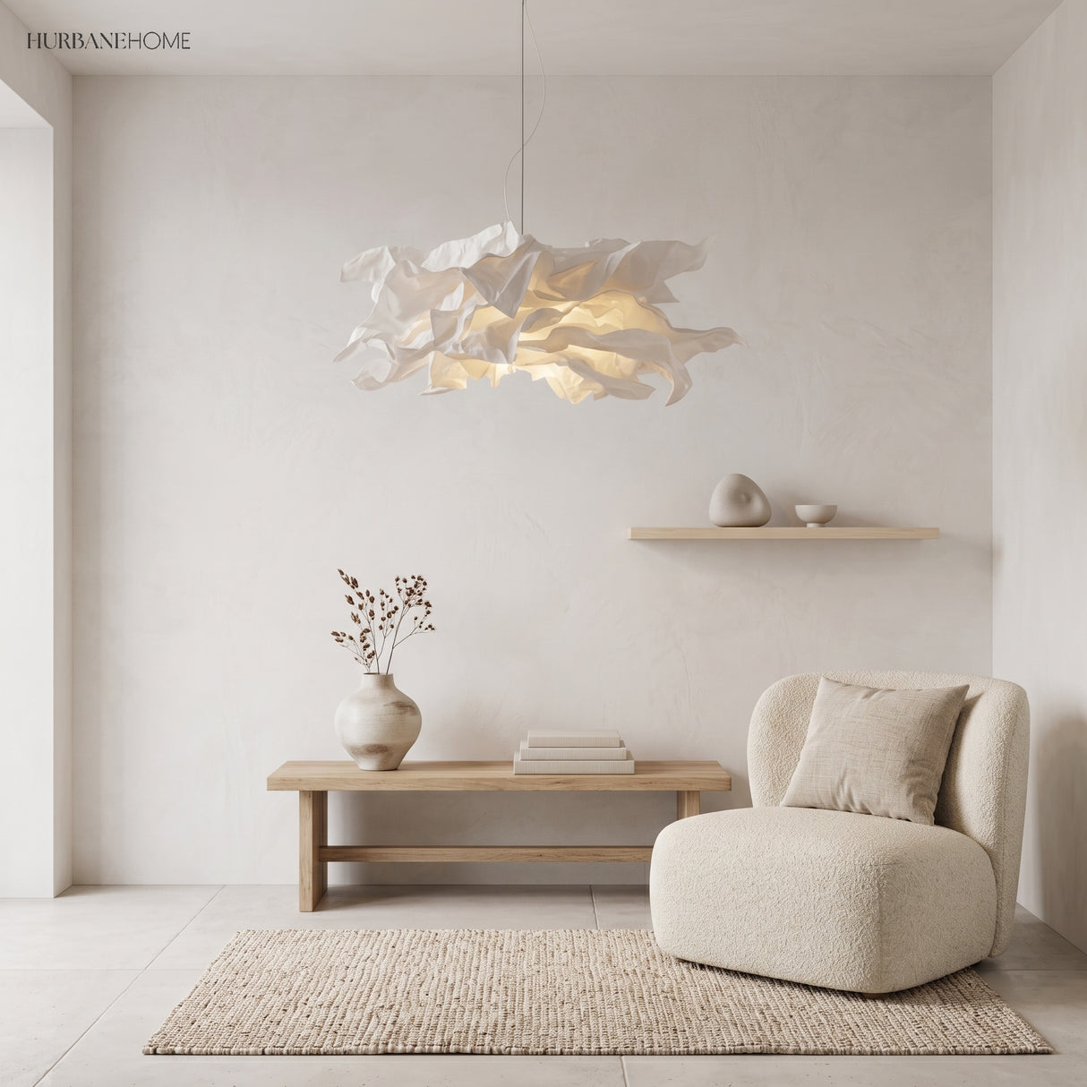 Folded paper pendant light over a wooden bench and cream boucle armchair