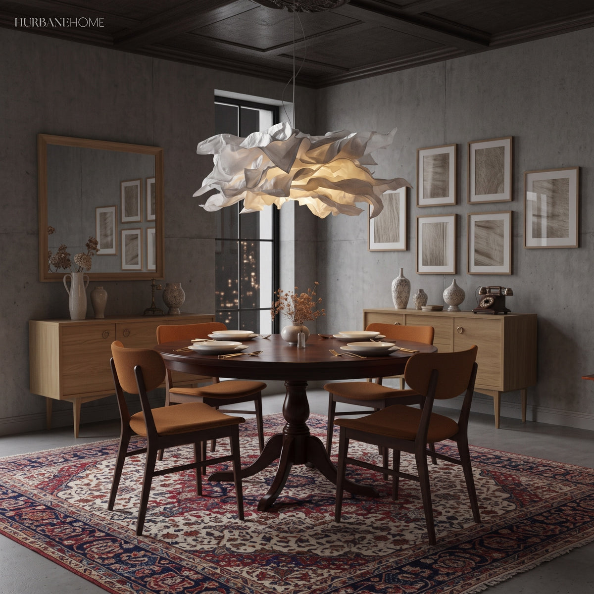 Paper pendant light over a dark dining room table with a patterned rug