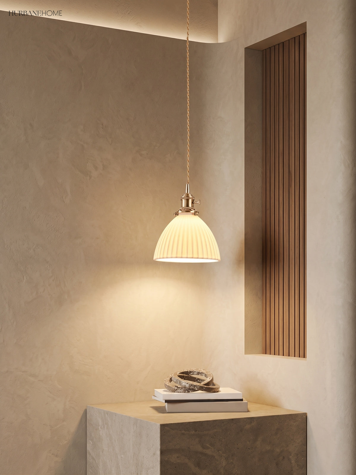 Pleated ceramic pendant lighting a plaster plinth beside slatted timber panel