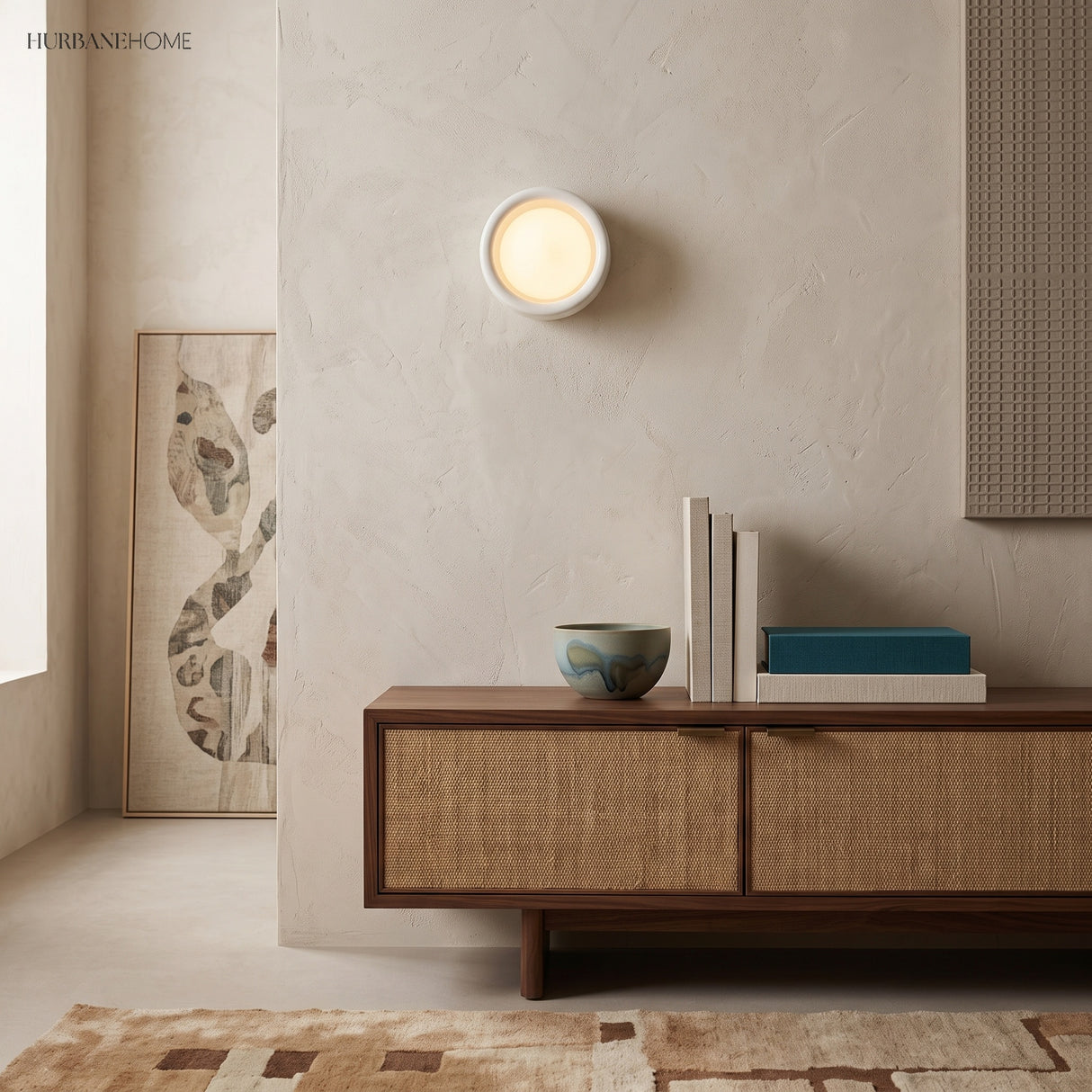 Flush porcelain disc wall light above a cane fronted sideboard