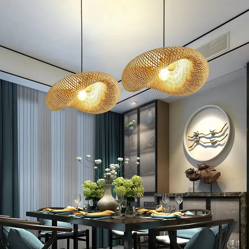 Bamboo pendant lit low over a timber tea table and stools