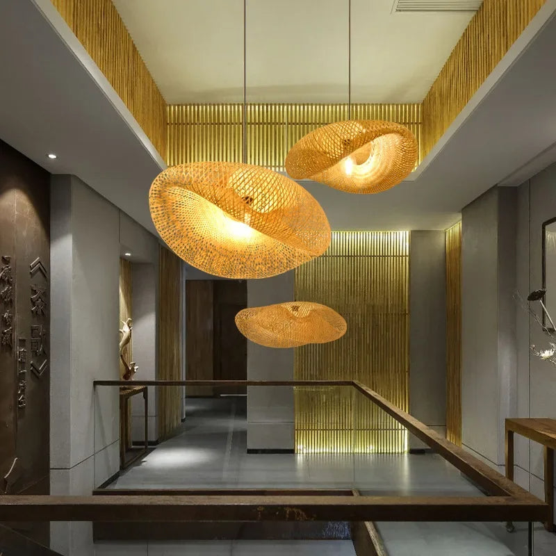 Woven rattan pendant above a dining table beside tall windows