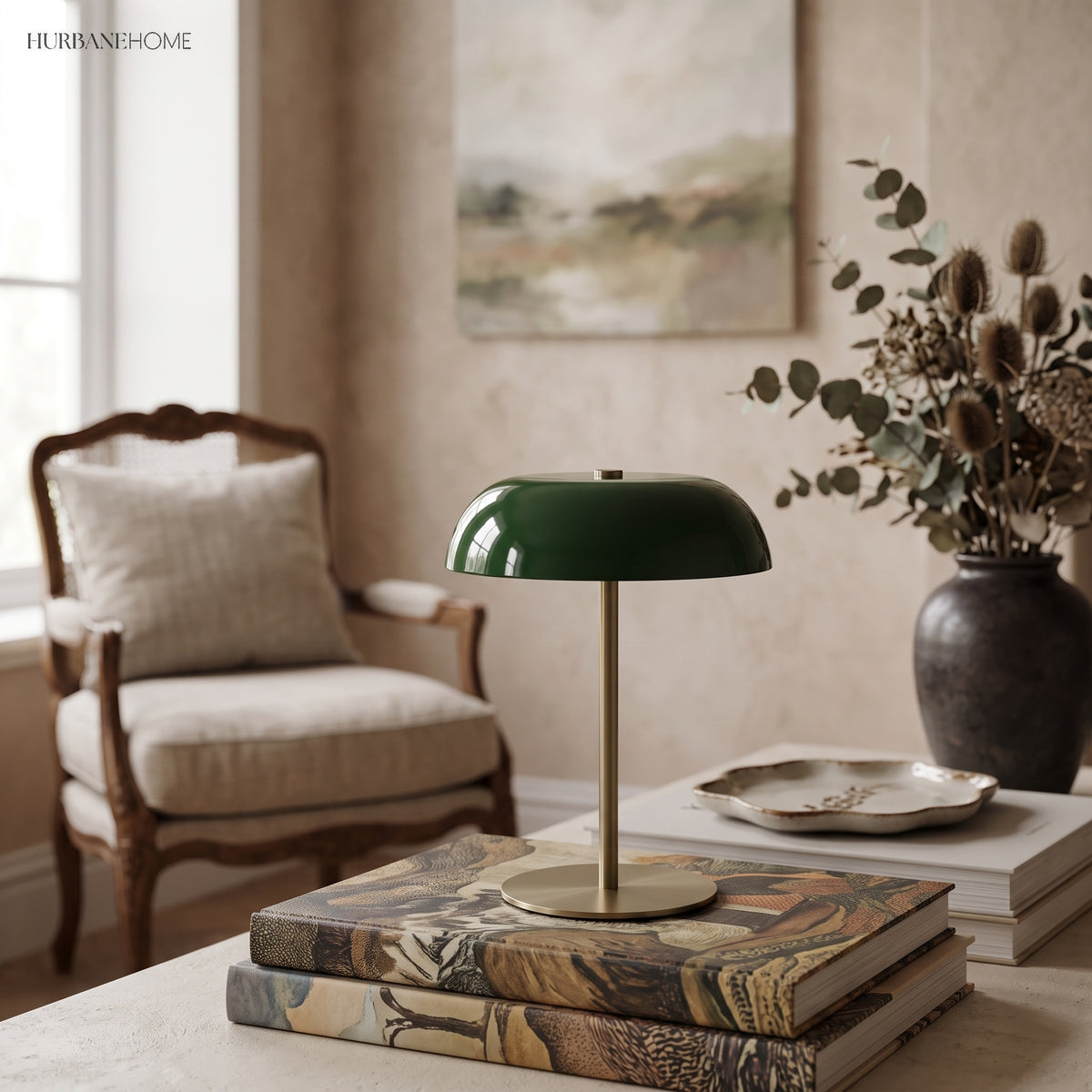 Green dome lamp on a book stack beside a cream armchair