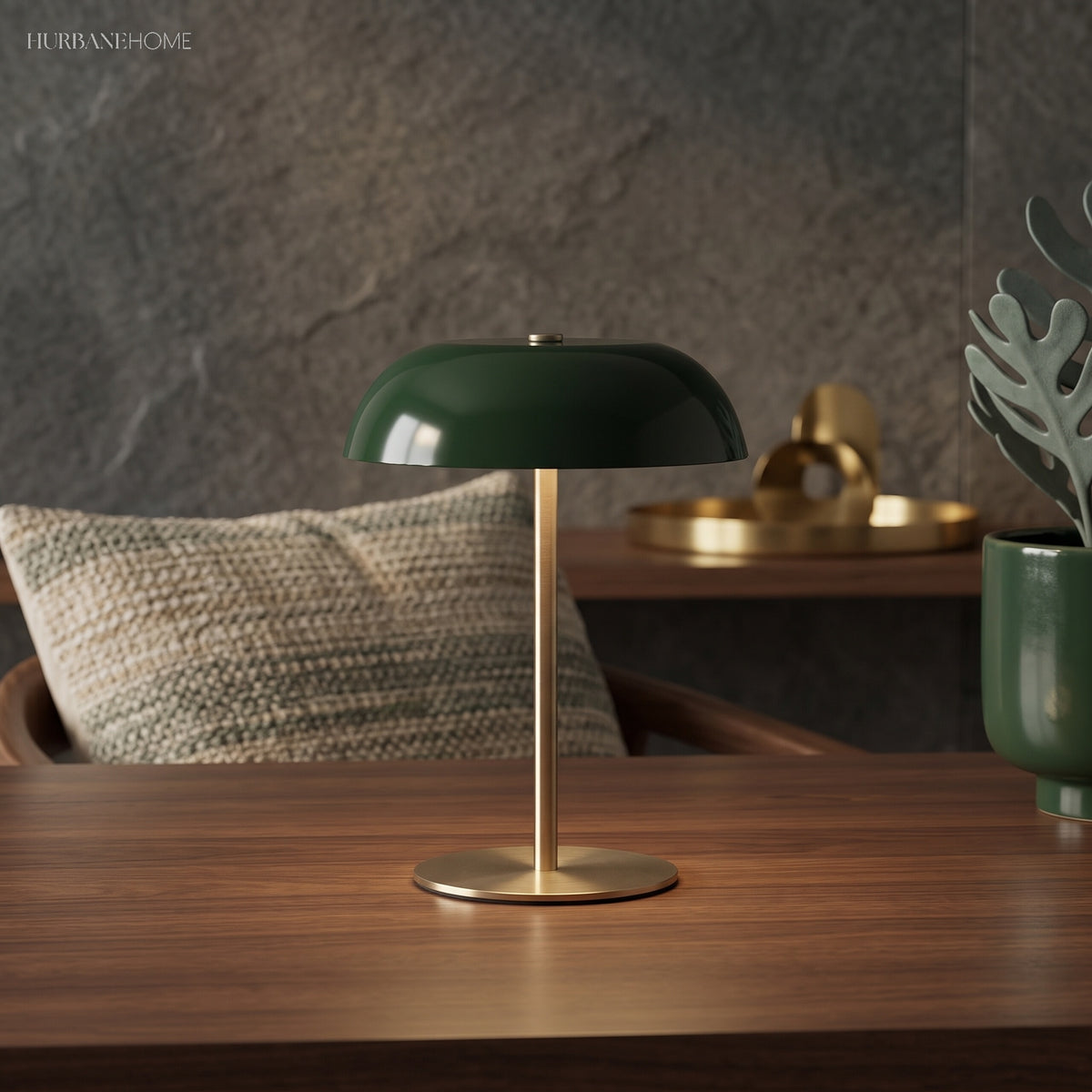 Green dome lamp glowing on a wooden console beside a stone wall