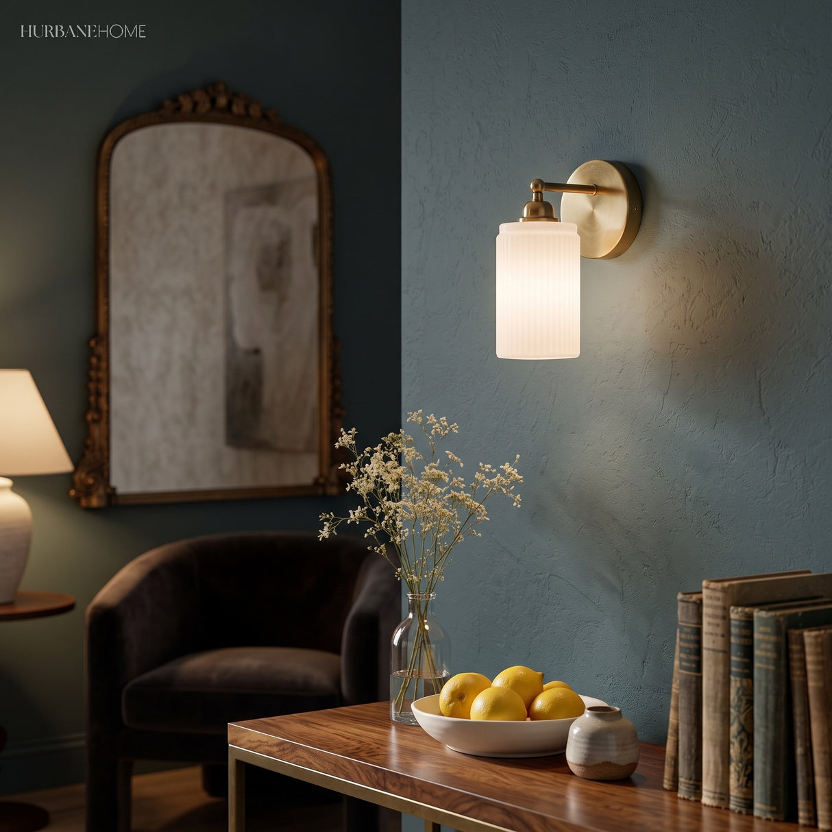 Brass ribbed glass sconce on a dark teal wall above a wooden table