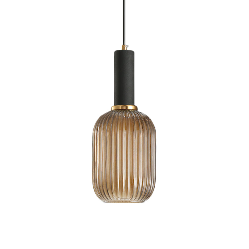 Amber ribbed capsule pendant with a black collar on white