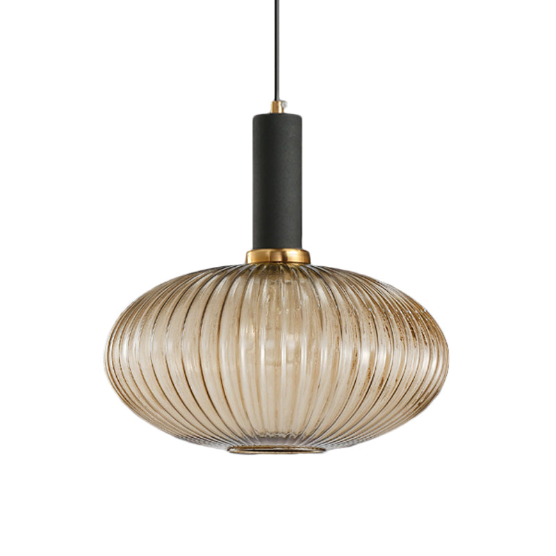 Amber ribbed oval pendant with a black collar, shown on white